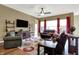 Inviting living room with a TV, warm lighting, and hardwood floors at 11072 Song Creek Ct, Fishers, IN 46040