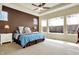 Inviting main bedroom features a tray ceiling, fan, neutral carpet and large windows for natural light at 11072 Song Creek Ct, Fishers, IN 46040