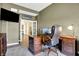 Cozy office with an executive desk, comfortable chair, and an adjacent sitting area at 11072 Song Creek Ct, Fishers, IN 46040