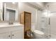 Bathroom with white vanity, shower, and woven storage cabinet at 11505 Langton Walk, Zionsville, IN 46077
