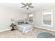 This neutral bedroom features soft carpet, a ceiling fan, and two windows for plenty of natural light at 11505 Langton Walk, Zionsville, IN 46077