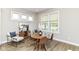 Cozy dining area with wood floors, natural light, and a round table with seating at 11505 Langton Walk, Zionsville, IN 46077