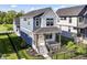 Charming two-story home with a front porch, dark iron railings and landscaped front yard at 11505 Langton Walk, Zionsville, IN 46077