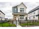 Charming two-story home with a covered front porch, black iron fence, and well-manicured landscaping at 11505 Langton Walk, Zionsville, IN 46077
