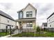 Charming two-story home with a covered front porch, black iron fence, and well-manicured landscaping at 11505 Langton Walk, Zionsville, IN 46077