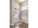 Bright foyer featuring a stylish rug, a white front door with a wreath, and a window with blinds at 11505 Langton Walk, Zionsville, IN 46077