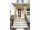 Inviting front entrance featuring a brown door with a wreath, black iron railings, and concrete steps at 11505 Langton Walk, Zionsville, IN 46077