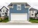 Blue-and-white two-car garage with a modern design and street access at 11505 Langton Walk, Zionsville, IN 46077