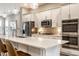 Kitchen featuring a large island with a white countertop, stainless steel appliances, and modern pendant lights at 11505 Langton Walk, Zionsville, IN 46077