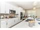 Well-appointed kitchen with white cabinets, granite countertops, and modern fixtures and equipment at 11505 Langton Walk, Zionsville, IN 46077