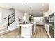 Open kitchen with stainless steel appliances, large island, and seamless flow to the living area at 11505 Langton Walk, Zionsville, IN 46077