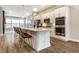 Modern kitchen featuring white cabinetry, quartz countertops, stainless steel appliances, and a large center island with seating at 11505 Langton Walk, Zionsville, IN 46077