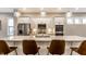 Modern kitchen with an island, pendant lighting, stainless steel appliances, and white cabinets at 11505 Langton Walk, Zionsville, IN 46077