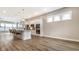 Open-concept kitchen featuring a large island with pendant lighting and stainless steel appliances at 11505 Langton Walk, Zionsville, IN 46077