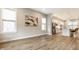 Open concept living room with modern lighting flowing into the eat-in kitchen at 11505 Langton Walk, Zionsville, IN 46077
