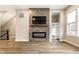 Open living room featuring modern fireplace, flatscreen, wood flooring, and built-in storage at 11505 Langton Walk, Zionsville, IN 46077