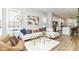 Inviting living room with large windows, hardwood floors, and a comfortable seating area at 11505 Langton Walk, Zionsville, IN 46077