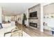 Stylish living room with modern fireplace, wood floors, and an open concept design at 11505 Langton Walk, Zionsville, IN 46077