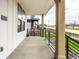 Spacious covered porch with concrete flooring, black iron railings, and views of the surrounding neighborhood at 11505 Langton Walk, Zionsville, IN 46077