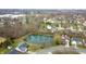 Wide aerial view of homes around a small lake, showcasing nearby community and natural features at 1156 E Mill Run Blvd, Greenfield, IN 46140