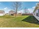 Expansive backyard with green grass, mature trees, and a wooden fence at 1156 E Mill Run Blvd, Greenfield, IN 46140