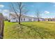 Backyard featuring a grassy area and the home's exterior at 1156 E Mill Run Blvd, Greenfield, IN 46140