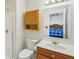 Bathroom with a wood vanity, white sink, and a large mirror reflecting the bedroom at 1156 E Mill Run Blvd, Greenfield, IN 46140