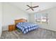 Cozy bedroom featuring a comfortable bed with a plaid comforter, a ceiling fan, and natural light at 1156 E Mill Run Blvd, Greenfield, IN 46140