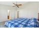 Bedroom featuring a blue plaid bedspread, ceiling fan and neutral carpet at 1156 E Mill Run Blvd, Greenfield, IN 46140