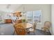 Cozy dining area with wood table set and lots of natural light from the large window at 1156 E Mill Run Blvd, Greenfield, IN 46140