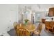 Bright dining area features a chandelier and a wooden table with seating for four at 1156 E Mill Run Blvd, Greenfield, IN 46140
