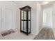 Inviting hallway showcasing a decorative display cabinet and a front door at 1156 E Mill Run Blvd, Greenfield, IN 46140