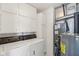 Laundry room with washer, dryer, storage cabinets, and utilities at 1156 E Mill Run Blvd, Greenfield, IN 46140