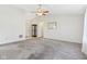 Spacious living room with neutral paint, plush carpeting, ceiling fan, and adjacent hallway at 1156 E Mill Run Blvd, Greenfield, IN 46140