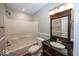 Bathroom with a combined tub and shower, toilet, and vanity with granite countertop at 11849 Wapiti Way, Noblesville, IN 46060