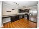 A modern kitchen with stainless steel appliances, granite countertops, and wood flooring at 11849 Wapiti Way, Noblesville, IN 46060
