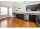 A kitchen with stainless steel appliances, dark cabinets and light granite countertops at 11849 Wapiti Way, Noblesville, IN 46060