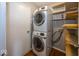 Efficient laundry area with stacked washer and dryer, and convenient shelving for storage at 11849 Wapiti Way, Noblesville, IN 46060