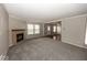 Spacious living room featuring plush carpeting, neutral paint, and a cozy brick fireplace at 11849 Wapiti Way, Noblesville, IN 46060