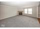 Bright living room with soft carpeting, fireplace and natural light from dual windows at 11849 Wapiti Way, Noblesville, IN 46060