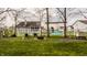 Well-maintained backyard with green grass, mature trees, and cozy seating area with a swing at 11925 Piney Glade Rd, Noblesville, IN 46060