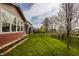 Lush backyard with green grass, privacy fence, and a covered area with seating at 11925 Piney Glade Rd, Noblesville, IN 46060