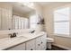 Bathroom with a double vanity, stone countertop, and modern fixtures at 11925 Piney Glade Rd, Noblesville, IN 46060