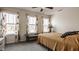 Light-filled bedroom with three windows, ceiling fan, and neutral decor at 11925 Piney Glade Rd, Noblesville, IN 46060