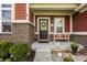 Inviting front porch with stylish seating and decorative accents, complemented by well-kept landscaping at 11925 Piney Glade Rd, Noblesville, IN 46060