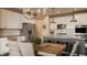 Charming kitchen featuring a rustic dining table, stainless steel appliances, and a stylish island with seating at 11925 Piney Glade Rd, Noblesville, IN 46060