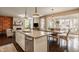 Spacious kitchen featuring a center island that flows into a naturally lit dining and living area at 11925 Piney Glade Rd, Noblesville, IN 46060