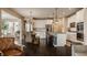 Bright kitchen with white cabinets, stainless steel appliances, and a rustic dining set adjacent to a comfortable living space at 11925 Piney Glade Rd, Noblesville, IN 46060