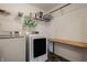 Bright laundry room with washer, dryer, shelving, and convenient folding space at 11925 Piney Glade Rd, Noblesville, IN 46060