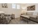 Cozy sitting room featuring a comfortable sofa, upholstered chair, and plenty of natural light at 11925 Piney Glade Rd, Noblesville, IN 46060